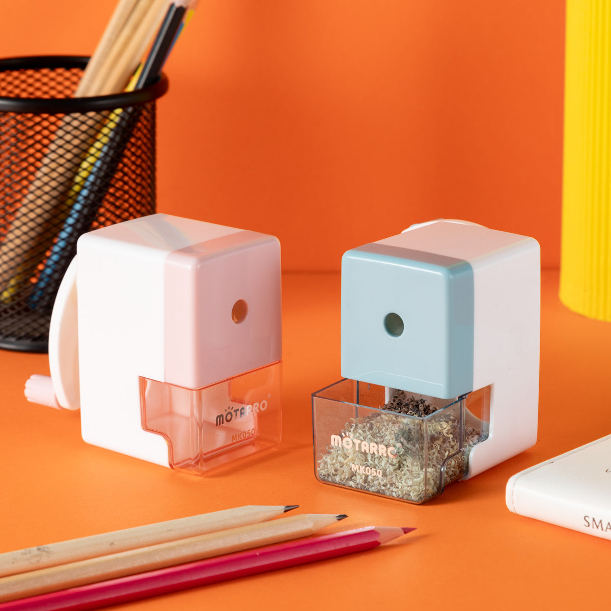 Motarro compact desk pencil sharpeners on a bright orange background